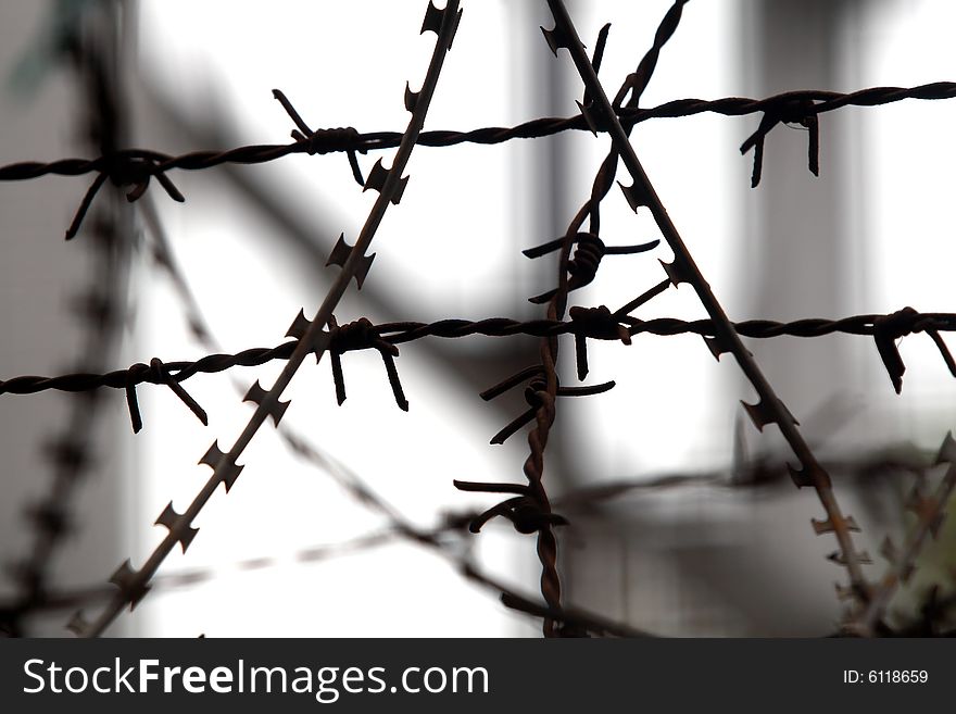 Lines of barbed wire with abstract background