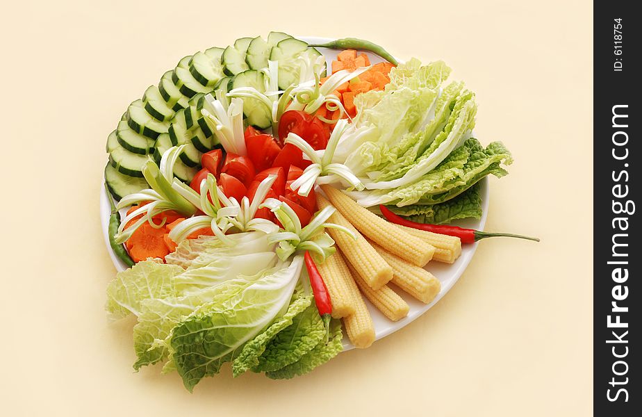 Fresh vegetables nicely arranged on white plate. Fresh vegetables nicely arranged on white plate.