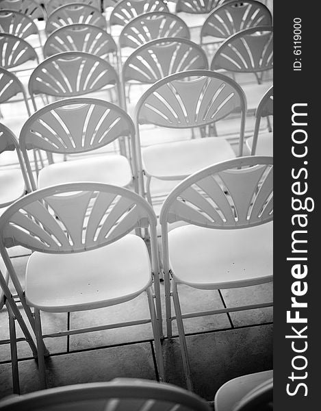 A black and white image of rows of chairs. A black and white image of rows of chairs