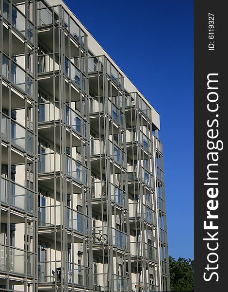 A closeup of elevation of a modern housing, balconies on steel structure visible, similarity and rhythm of subdivisions