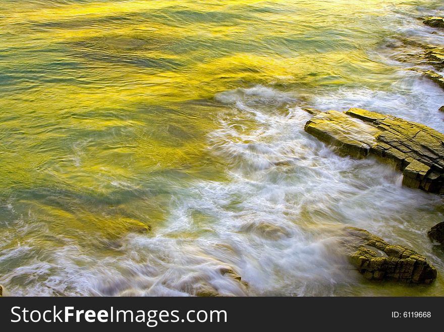 Wave Washing On Rocks