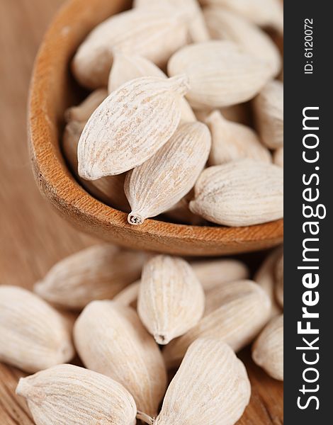 White Cardamom In Wooden Spoon