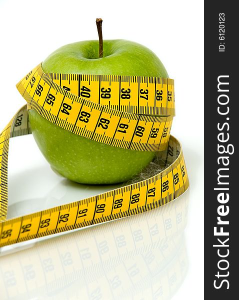 Apple in measuring tape over a white background. Apple in measuring tape over a white background