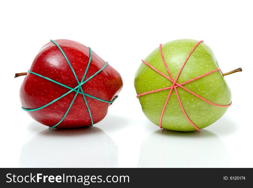 Apple tied in rubber bands over a white background. Apple tied in rubber bands over a white background