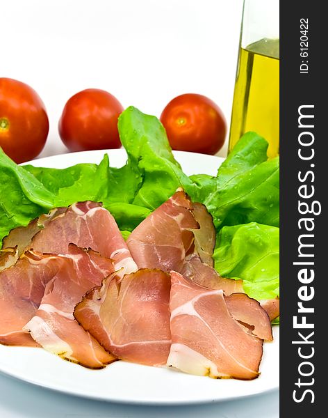 many smoked slices of ham with salad.