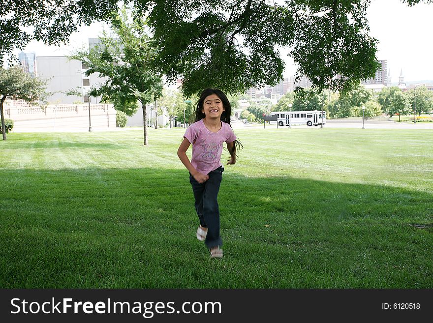 Smiling Girl running across yard