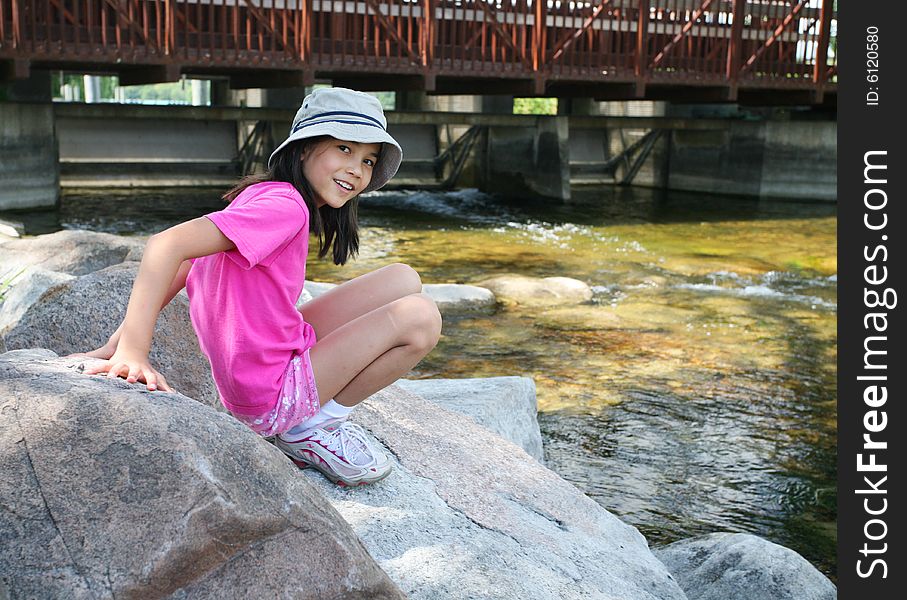 Little girl playing on rocks