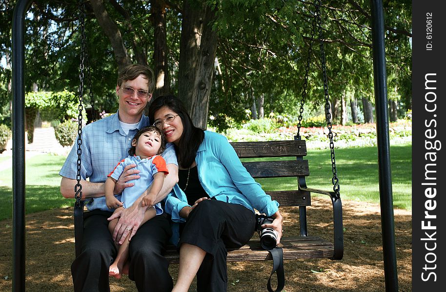 Family of three on swing seat