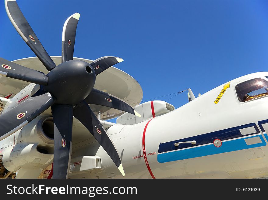 A military sentry plane with an eight blade propeller and a dome on top.