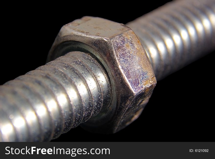 Close up of a nut screwed onto a bolt. Close up of a nut screwed onto a bolt.