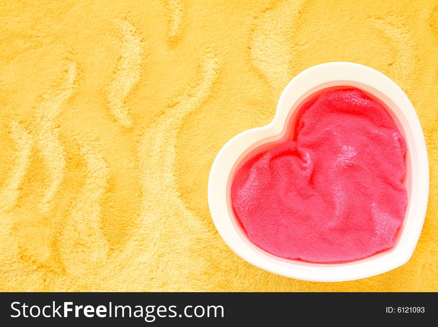 A colorful photograph of a heart shaped object on a yellow background. A colorful photograph of a heart shaped object on a yellow background.