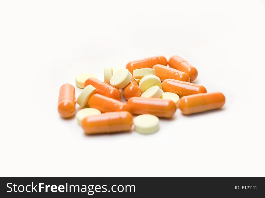 A few orange pills, isolated over white background. A few orange pills, isolated over white background