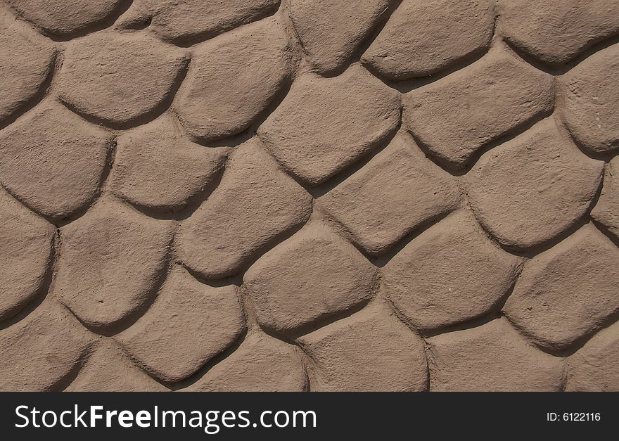 A part of a stone wall. It's surface is plastered.