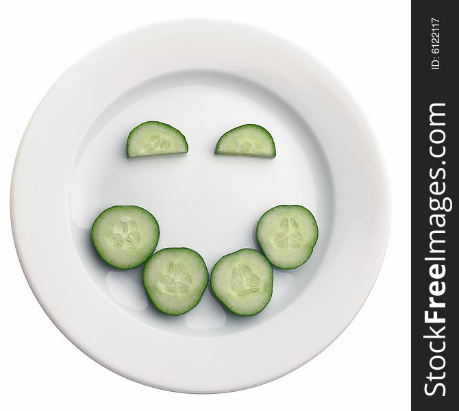 Positive face expression from cucumber's slices on the plate, isolated on white. Positive face expression from cucumber's slices on the plate, isolated on white.