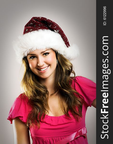 Winter portrait of a beautiful young smiling woman with a christmas cap. Winter portrait of a beautiful young smiling woman with a christmas cap