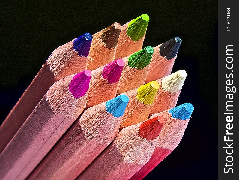 Multicolor pencils on black background