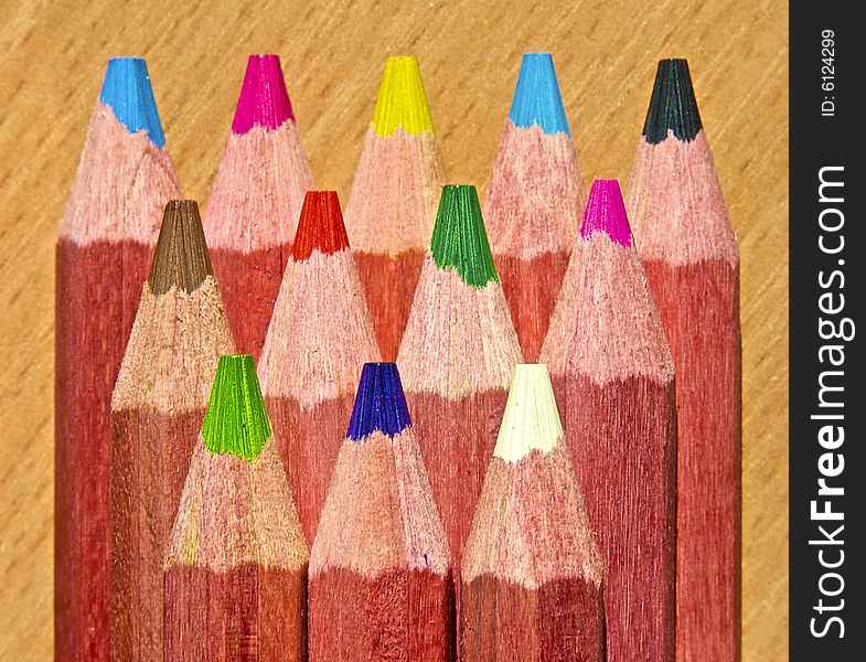 Multicolor pencils on wooden background. Multicolor pencils on wooden background