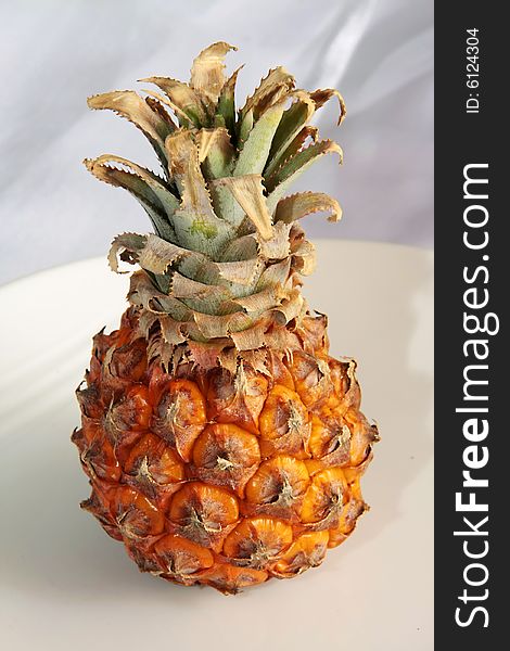 An ripe pineapple on a white background