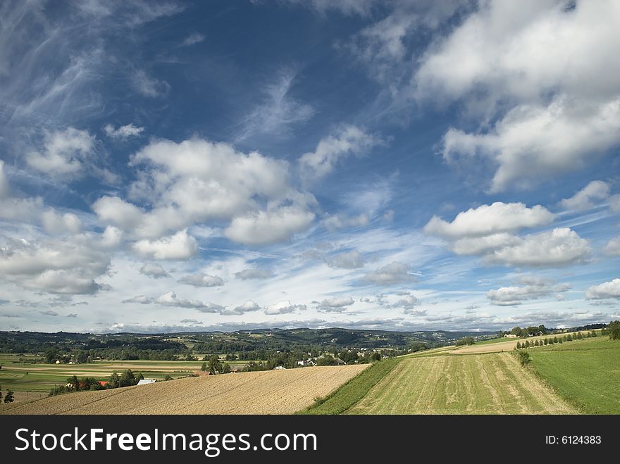 Stunning upland landscape with blue sky and lot of clouds - Poland