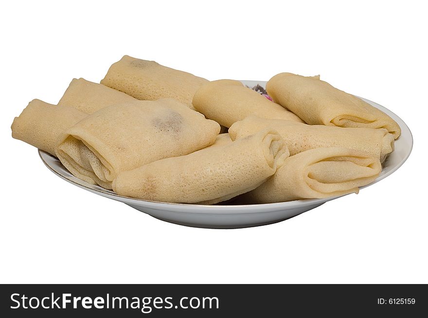 Dish with pancakes on white background