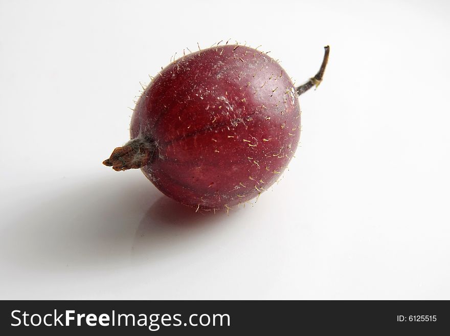 Big ripe gooseberry on a grey background