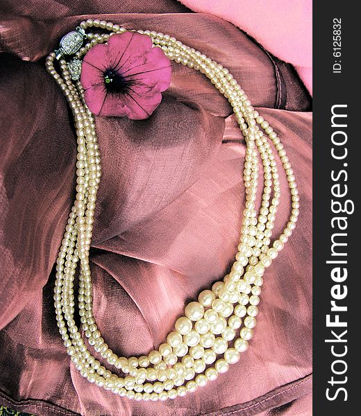 Necklace from white ocean pearls, pink textile and magenta flower. Necklace from white ocean pearls, pink textile and magenta flower.