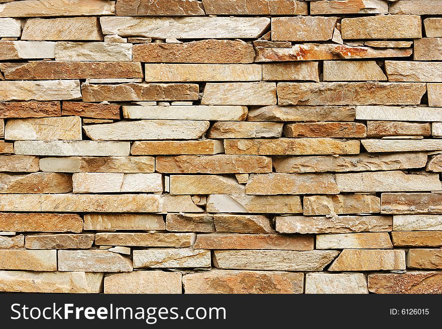 Irregular brick wall with various tint and forms of brick