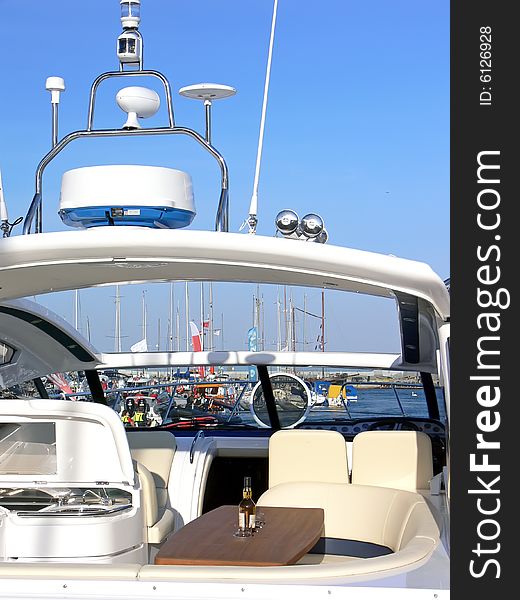 Luxury yacht equipment. Sink, leather sofa, wooden table and bottle with glasses. Luxury yacht equipment. Sink, leather sofa, wooden table and bottle with glasses.