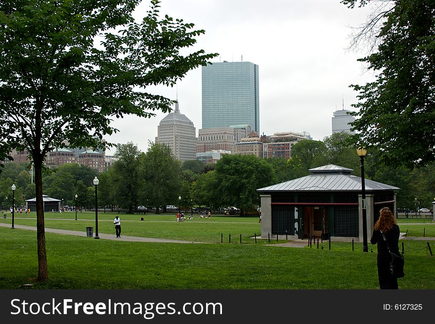 Classic boston skyline above the common showing tourists, trees and buildings. Classic boston skyline above the common showing tourists, trees and buildings