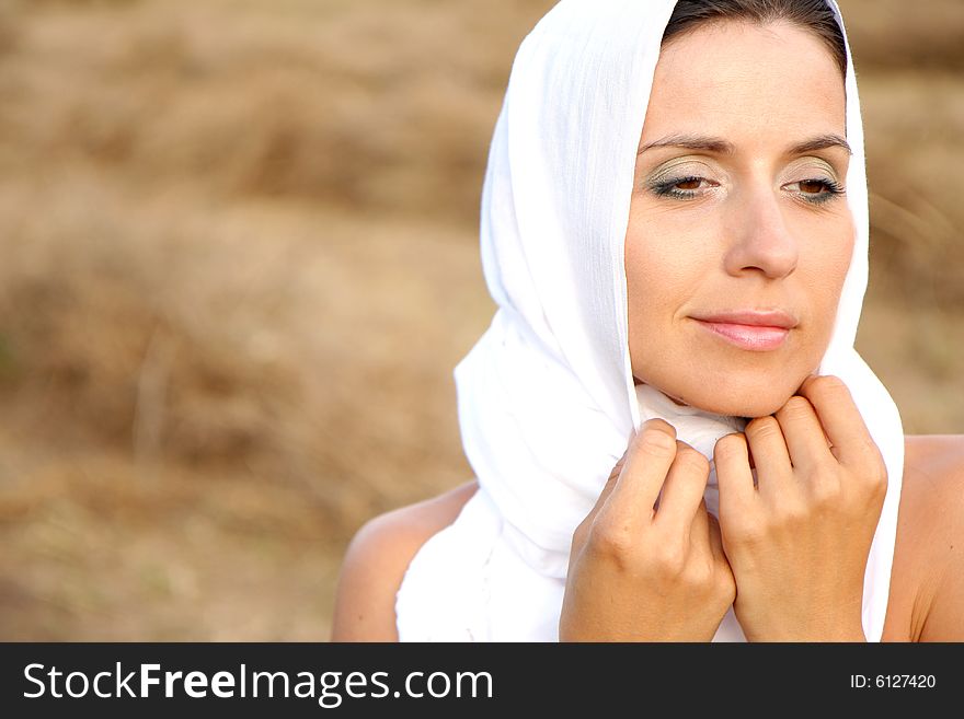 Purity woman on field with white scarf and clean face