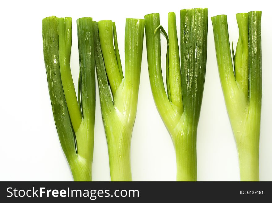 Stack of fresh green onions sprouts on a white background. Stack of fresh green onions sprouts on a white background.