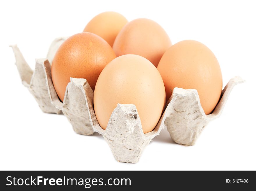 Five eggs in cartons cell. Brown. Isolated on a white background. Five eggs in cartons cell. Brown. Isolated on a white background.
