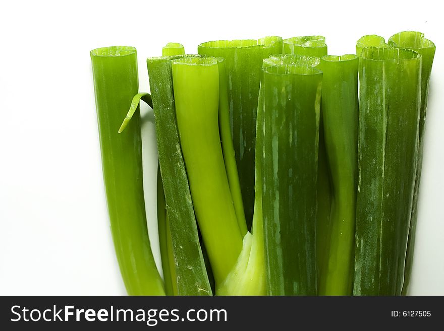 Stack of fresh green onions sprouts on a white background. Stack of fresh green onions sprouts on a white background.