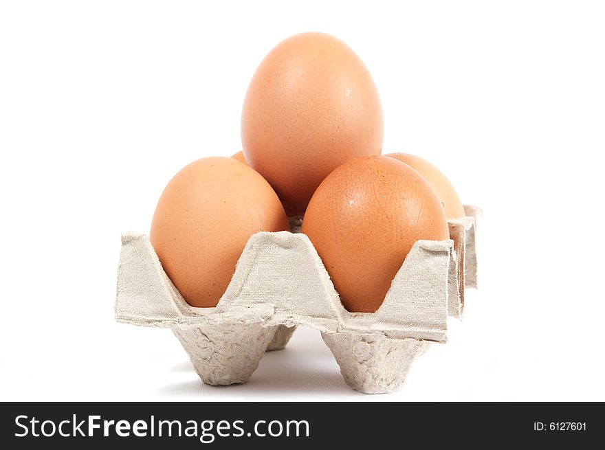 Pyramid of the five eggs. In cartons cell. Brown. Isolated on a white background. Pyramid of the five eggs. In cartons cell. Brown. Isolated on a white background.