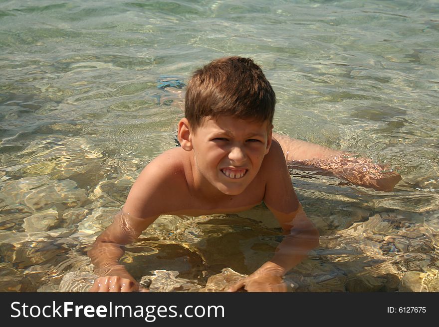 Boy on a beach ready to swim. Boy on a beach ready to swim