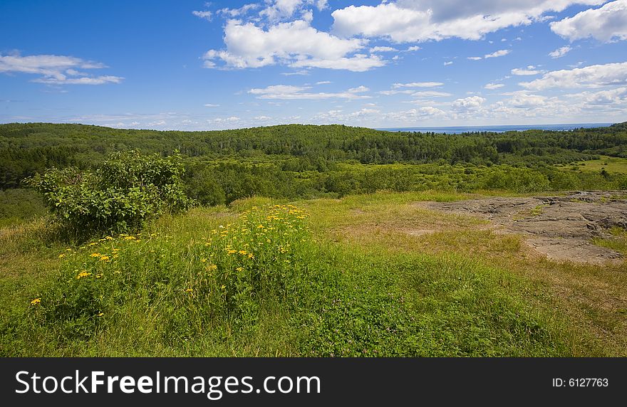 The vast forest landscape of the North woods of Minnesota overlooking Lake Superior in the distance.