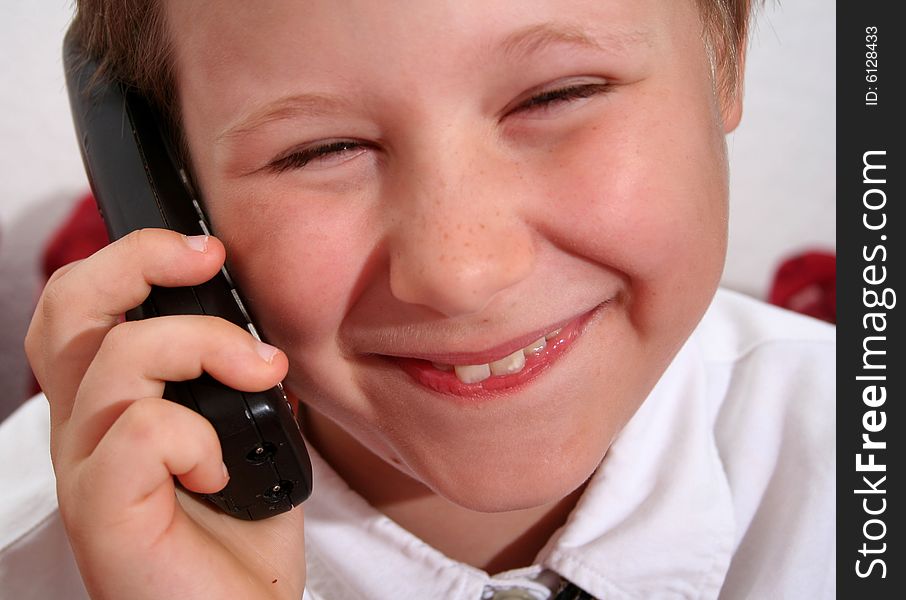 A sweet young boy on the phone