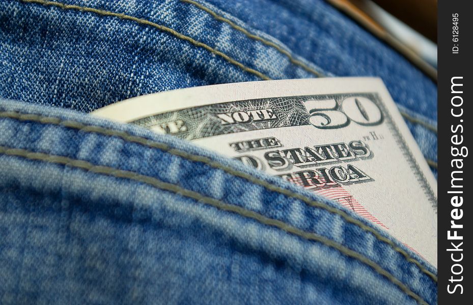 Dollars in back pocket of jeans