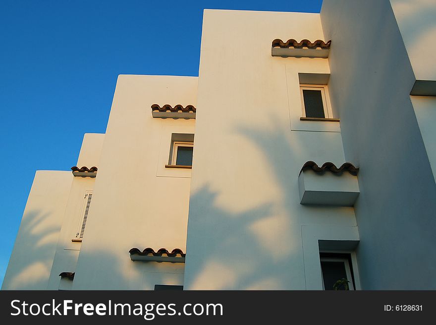 White building, window 
against the blue sky