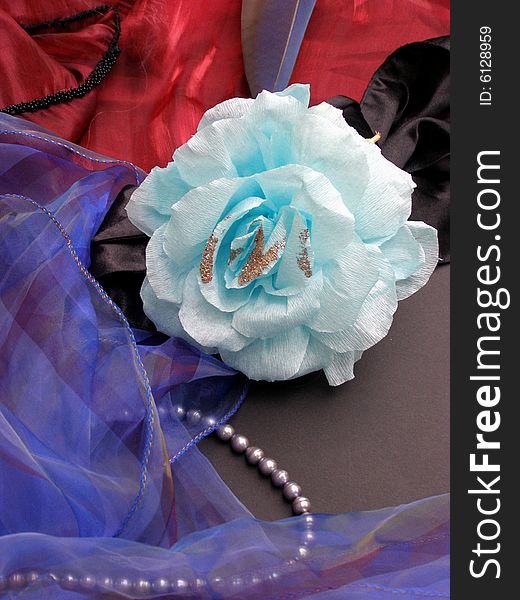 Paper rose from blue color with coloured textiles and grey pearls. Paper rose from blue color with coloured textiles and grey pearls.