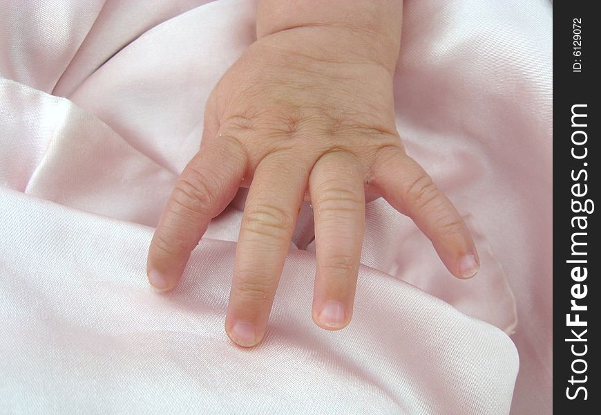 Baby girl hand on pink blanket. Baby girl hand on pink blanket
