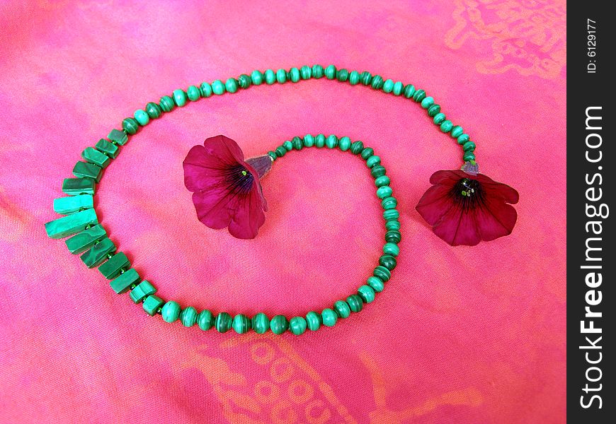 Necklace from green stones, pink textile and magenta flower. Necklace from green stones, pink textile and magenta flower.