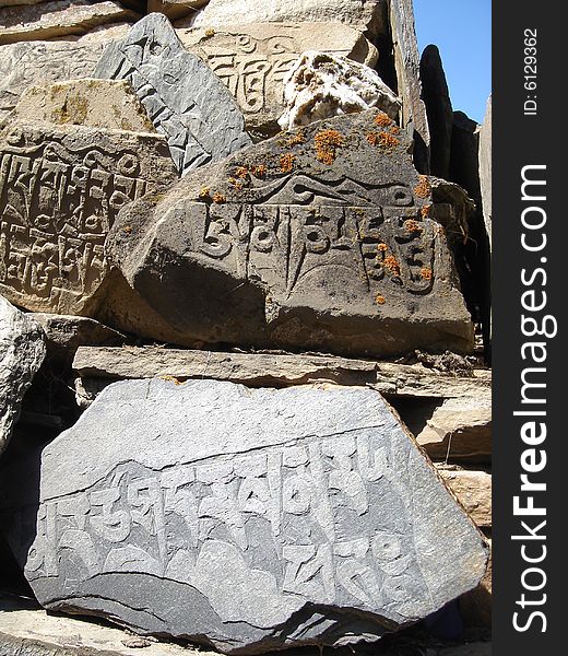 Nepali people write holy text on stones. Nepal, April 2008