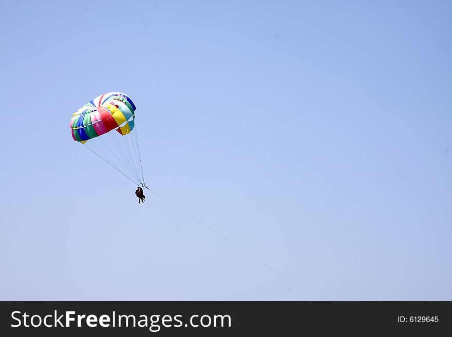 Parachute fly on the blue sky