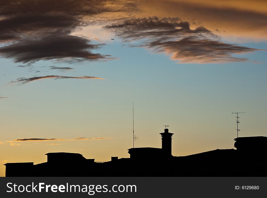 A silhouette of buildings at dusk. A silhouette of buildings at dusk