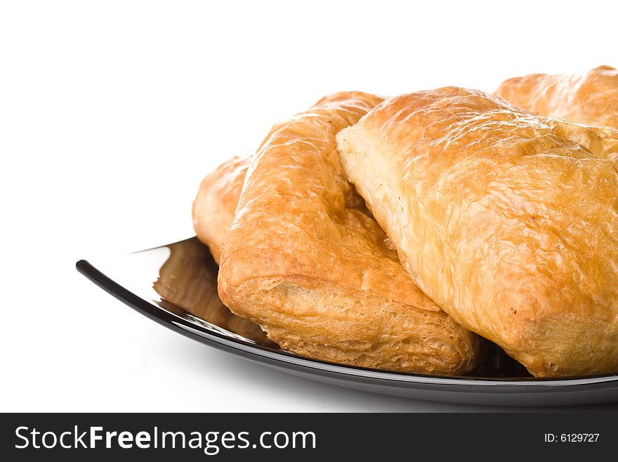 Fresh rolls on a plate on a white background