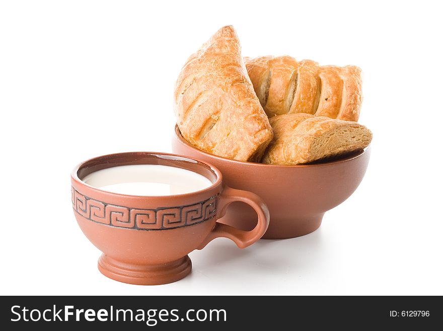 Appetizing pie and cup of milk on a white background