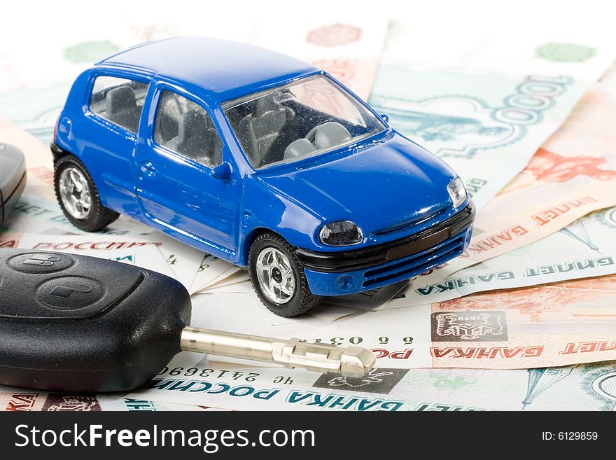 Car, keys and money on a white background