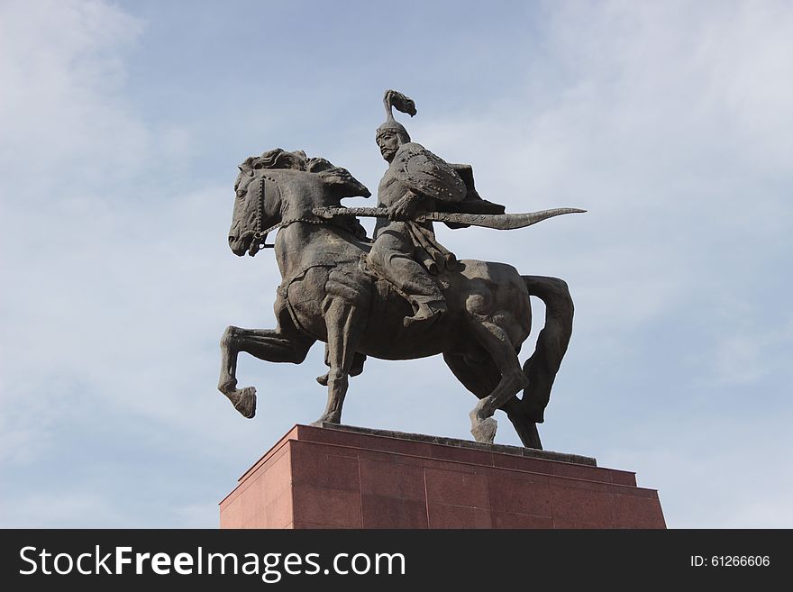 A statue depicting Manas, the legendary kyrgyz national hero. It's located in front of the history museum in downtown Bishkek, capital of Kyrgyzstan. A warrior on horseback. A statue depicting Manas, the legendary kyrgyz national hero. It's located in front of the history museum in downtown Bishkek, capital of Kyrgyzstan. A warrior on horseback.