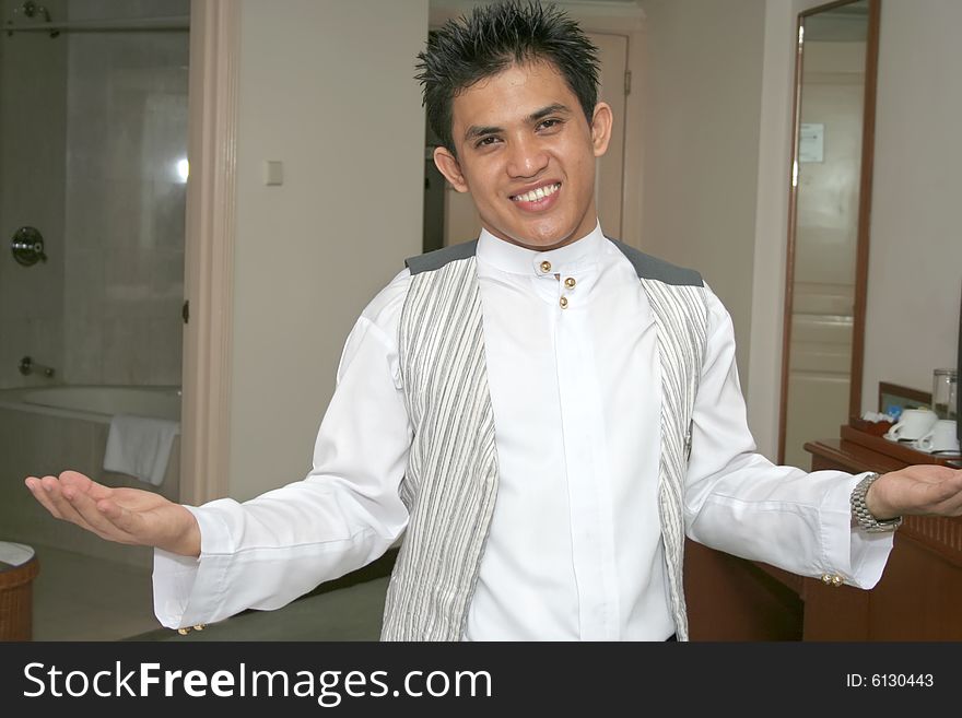 Room service waiter pose in hotel smiling